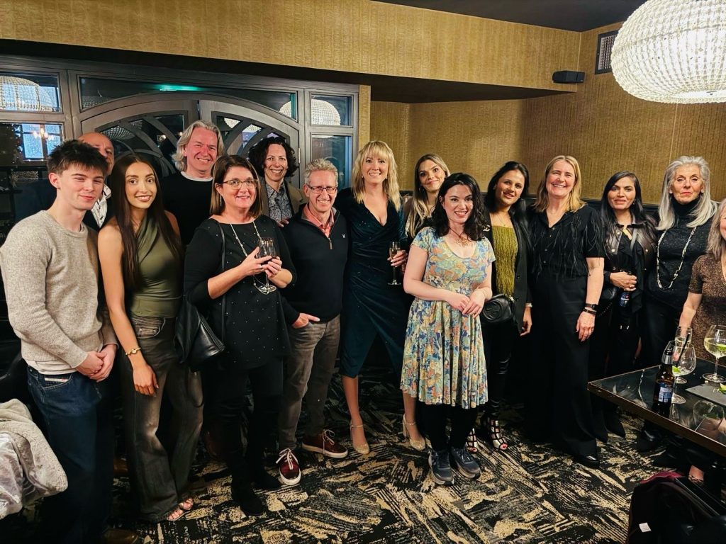 A group photo from a HelloHope event, the group are dressed for a celebration